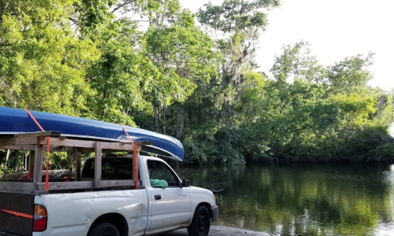 A truck parked in front of the waterway