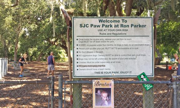 The dog park sign letting guest's know the rules and regulations of the area