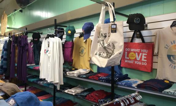 Clothing and totes arranged along the wall