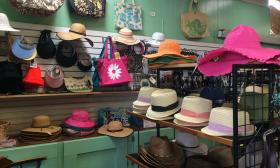 An assortment of hats and bags on display inside the shop