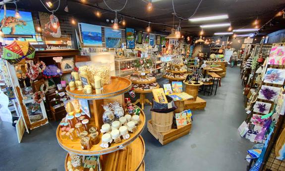 An interior of First Look, the Artisans Market in St. Augustine, FL. Various antiques are on display tables.