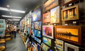 An interior of First Look, the Artisans Market in St. Augustine, FL. Many paintings and photographs are on the wall.