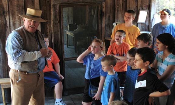 A guide giving a tour for the Old Florida Museum at the Florida Agricultural Museum. 