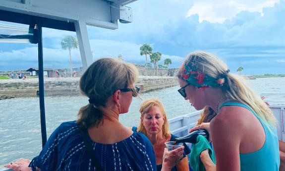 Friends enjoying wine on an evening cruise with Florida Water Tours of St. Augustine.