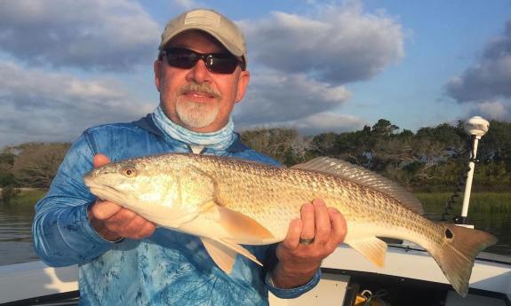 A fisherman holding a fish