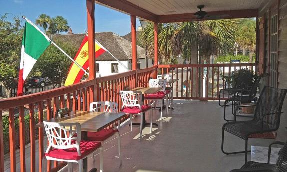 St. Augustine's Casa Maya offers outdoor seating on their balcony overlooking Hypolita Street.