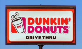 A sign advertising Dunkin' Donuts 