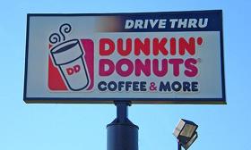 A sign advertising Dunkin' Donuts drive-thru and coffee