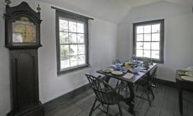 Dining room in the Oldest House with large antique Grandfather clock; indicative of the period. 
