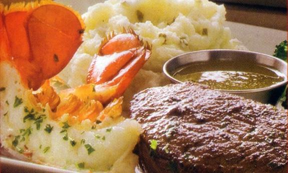 Ruby Tuesday's Steak and Lobster plate with a side of mashed potatoes and dipping butter