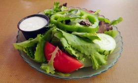 Salad featuring greens and tomato from Sonny's bottomless salad bar
