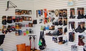 Bike gear and parts displayed along the wall inside the store
