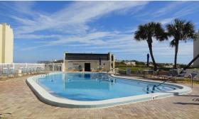 Relax by the pool at Tradewinds Vacation Rentals in St. Augustine, Florida. 