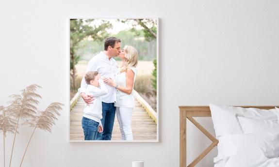 A photo of a family of three, taken by photographer Jackie Hird, and hanging in their master bedroom in St. Augustine.