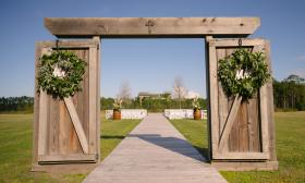 Jade Violet Wedding Floral decorated this rustic gate for a destination wedding in St. Augustine. Photo by Life and Love Studios.