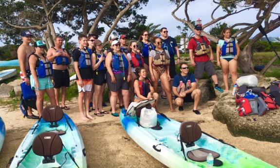 A large group of kayakers gather ashore on a trip with Kayaking St. Augustine.