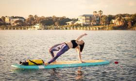 Woman doing yoga on paddle board in St. Augustine 