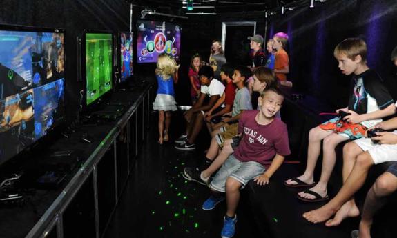 Kids playing video games inside the mobile bus