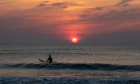 Surfing at sunrise, a photo by Milo Davis, Photographer in St. Augustine.
