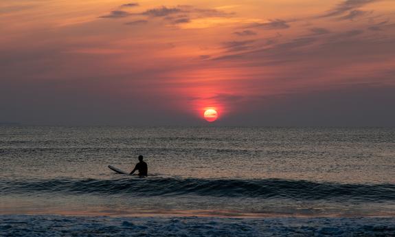 Surfing at sunrise, a photo by Milo Davis, Photographer in St. Augustine.