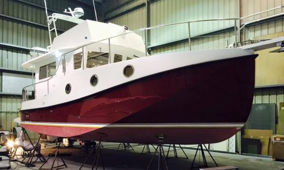 A large powerboat getting work done in a shed at Oasis Boat Yard and Marina in St. Augustine.