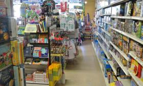 A variety of children's books and games along the aisle