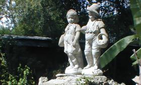Statues in the courtyard garden of St. Augustine's Oldest Wooden School House.