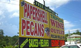 A sign promoting the pecan goods at the roadside shop