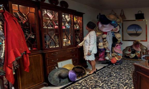 The interior of the shop with hats, jewelry, and clothes arranged around the space