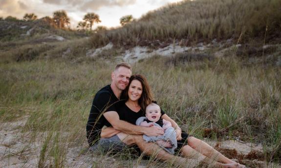 A family being photographed by Sydney Roessling Photography in St. Augustine Beach.