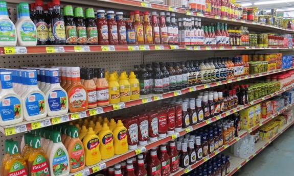 The selection of salad dressings, condiments, and all things barbeque presented