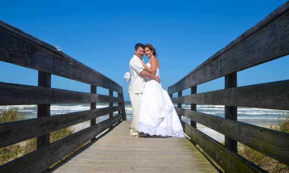 couple standing on boardwalk 