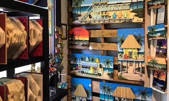 Paintings on wood and novelty books at Zora Bora Gallery in St. Augustine.