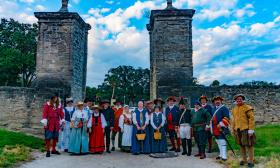 Numerous reenactor groups standing at City Gate in St. Augustine.