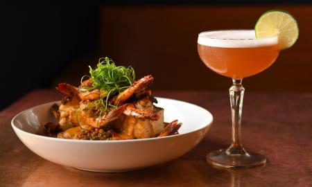 A dish of food and a cocktail