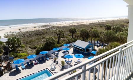 The Tiki Bar and the beach viewed from an upper deck at Guy Harvey Resort