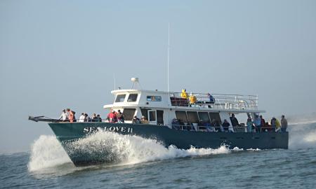 The larger fishing boat for Sea Love Charters heading out to sea