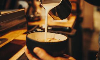 A barista at one of St. Augustine's Kookaburra coffee shops, preparing a hot drink for a guest