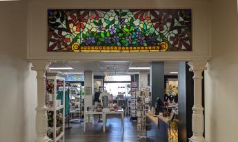 The entrance to the Lightner Museum Store, with a stained-glass transom