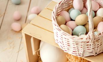 Colorful Easter eggs are positioned in a basket. 
