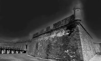 An eerie black and white photo of the Castillo de San Marcos in St. Augustine, Florida