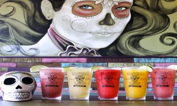 Cantina Louie Fro-Jo-Ritas in front of mural