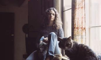 Carole King and her cat, sitting in a window, from the cover of her album "Tapestry"