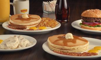 Breakfast options at Denny's including biscuits and gravy, pancakes, coffee, and juice