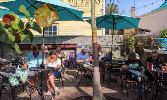 Guests at Pierre's Pub relax in the outdoor listening area