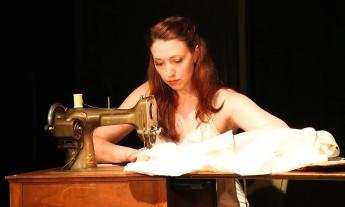 Lisa Egan Woods, actor and playwrite, performs at a sewing machine during her play, "Thread and Bone"
