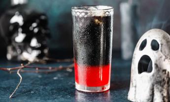 A cocktail and a ghost on the bar