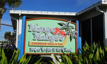 A sign advertising Mango Mango's Caribbean Bar & Grill