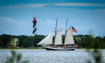 The Schooner Freedom sailing past the lighthouse on Anastasia Island