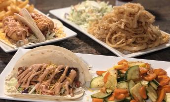 Different types of tacos and sides plated